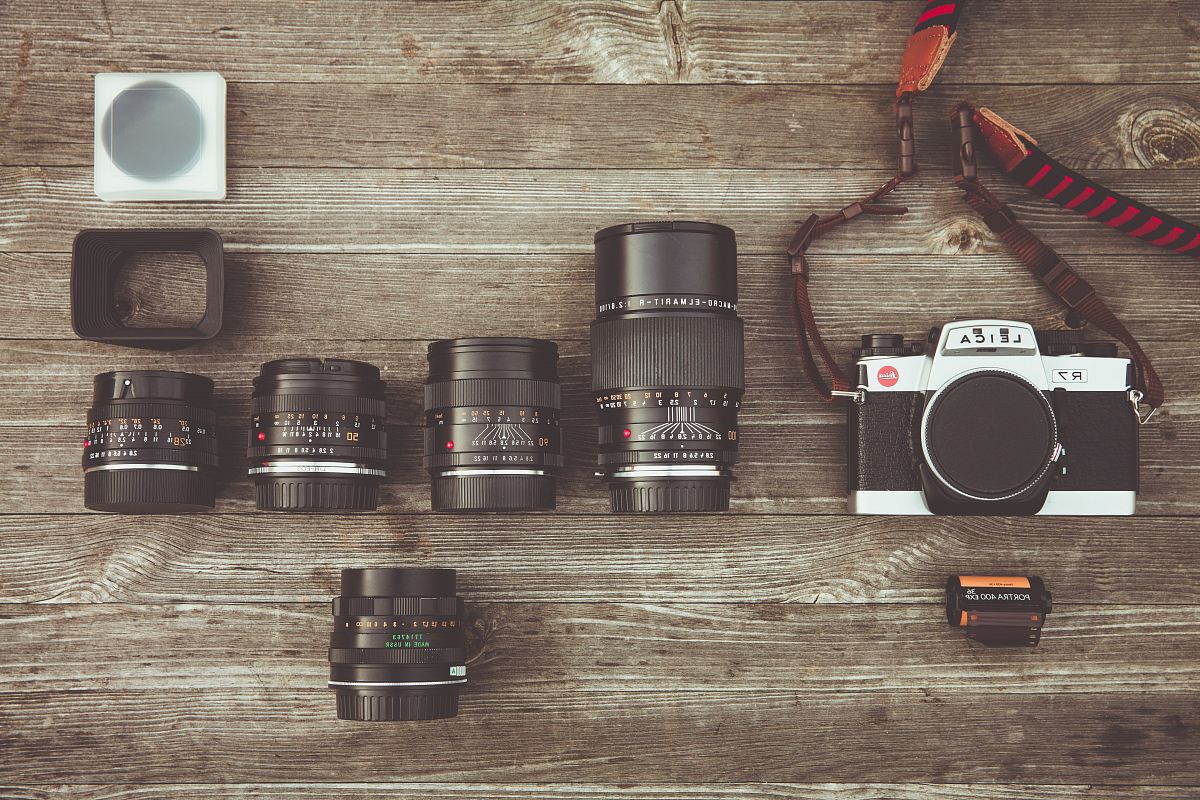 black and gray DSLR camera and lens on table